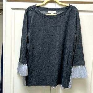 Grey sweater with blouse on back